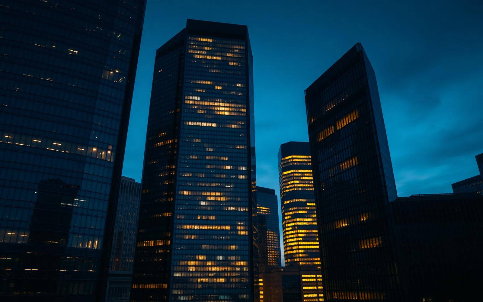 Institutional financial district towers at dusk.